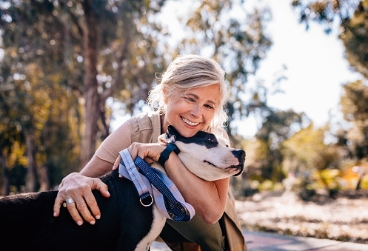 smiling woman hugging a dog